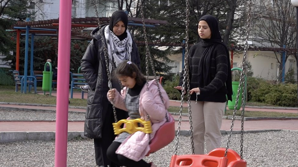 Mona Al Shorafi with her two daughters at a park