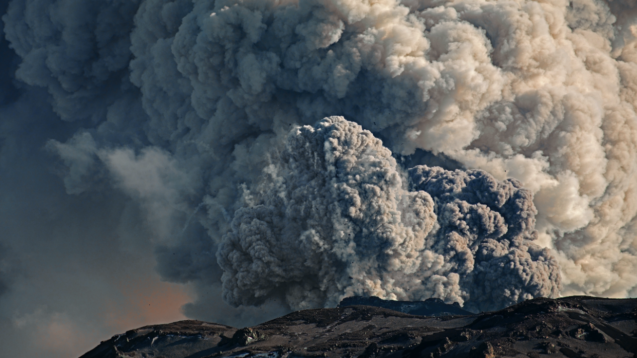 Volcano erupting with large amounts of ash entering the sky